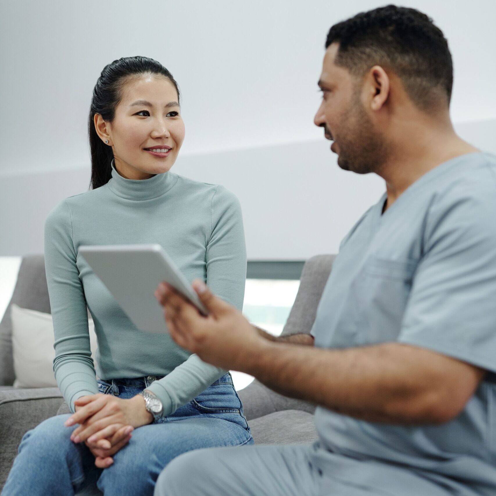 Effective Patient Communication A physician effectively communicates with a happy patient.