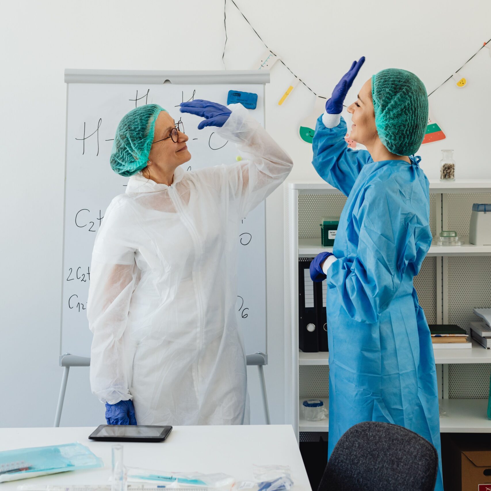 Two healthcare professionals share a high five.